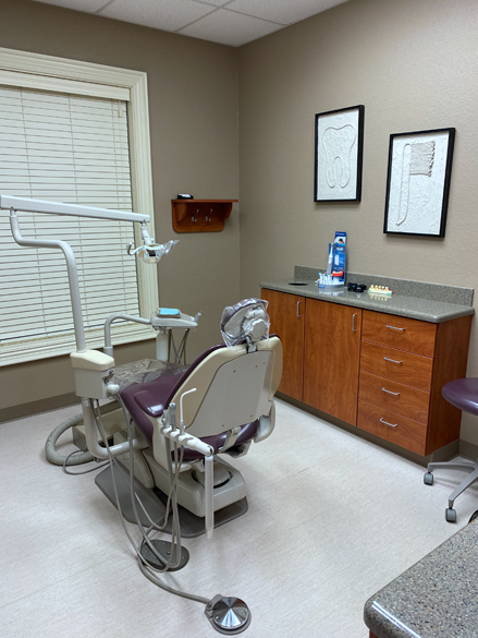 dentist room with chair, sink and surrounding equipment