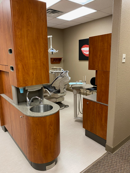 dentist treatment room with sink and chair